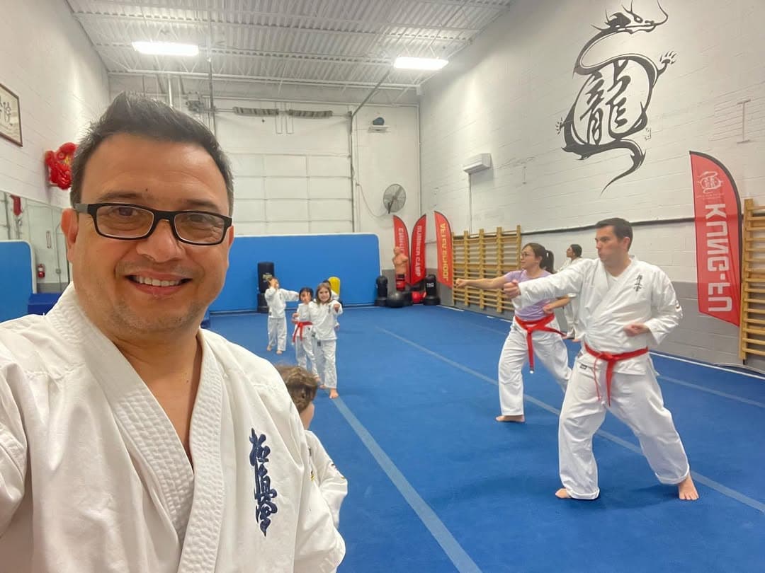 Karate instructor demonstrating form to children in Gaithersburg